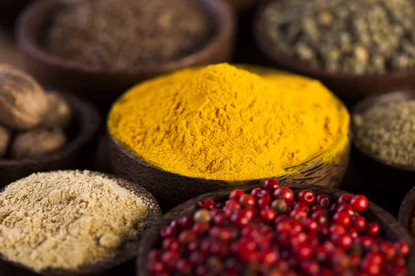 Wooden table of colorful spices — Stock Photo, Image