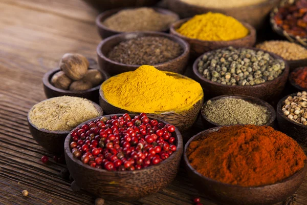 Wooden table of colorful spices — Stock Photo, Image