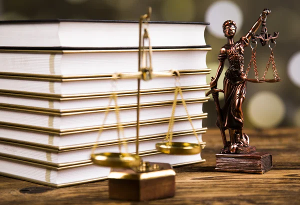 Golden scales of justice, books, Statue of Lady Justice. Owl and paragraph