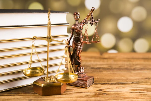 Golden scales of justice, books, Statue of Lady Justice. Owl and paragraph
