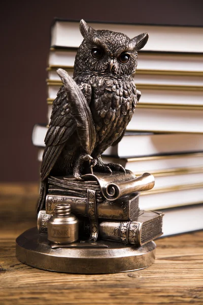 Golden scales of justice, books, Statue of Lady Justice. Owl and paragraph