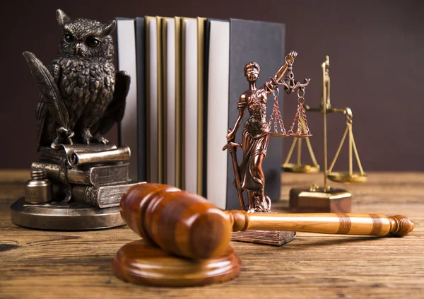 Golden scales of justice, books, Statue of Lady Justice. Owl and paragraph