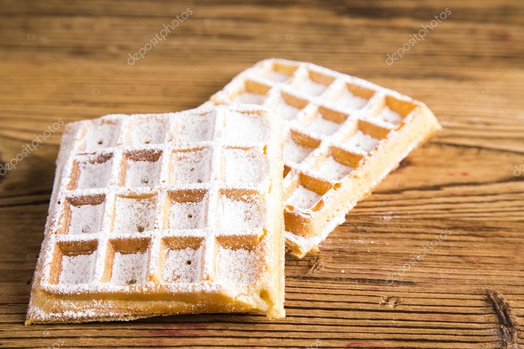 Waffles with whipped cream and raspberries and cranberries,  Waffles with icing sugar