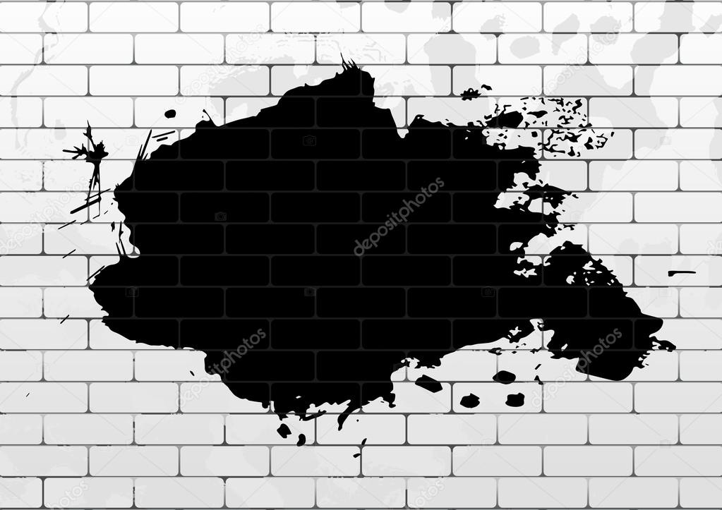 White brick wall with black paint blot 
