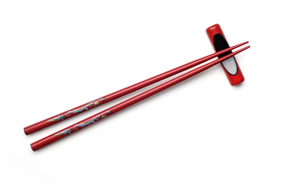 Czerwony drewniany chopstick z reszta chopstick — Zdjęcie stockowe