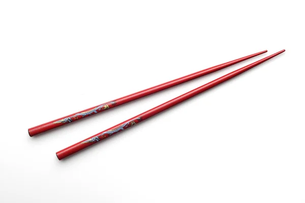 Červené dřevěné hůlky s modrými a žlutými drak. — Stock fotografie