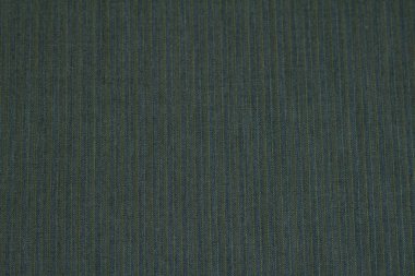 Textured background of wool fabric in a small stripe of blue-green colors for warm winter clothing. Horizontal orientation