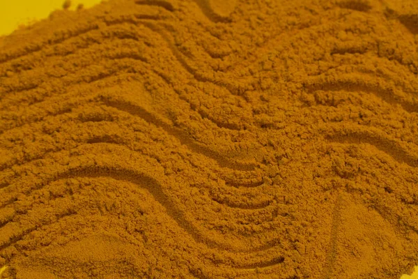 Ground turmeric powder is scattered like sand in the desert. Grocery background.Copy space. — Stock Photo, Image