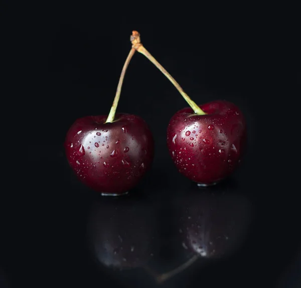 Close-up of cherry berries on a black background.