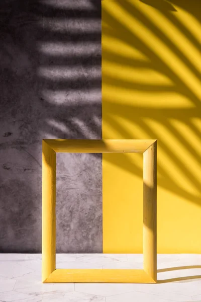 Abstract shadows on a gray-yellow background for the sale of a cosmetic product, a cosmetic showcase in a minimalist style. Trending colors 2121