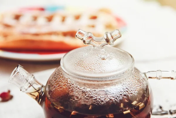 The Black Tea in the Glass Teapot,with Perspiration;Tea Drinking,Aromatized Flowers,Toned — Stock Photo, Image