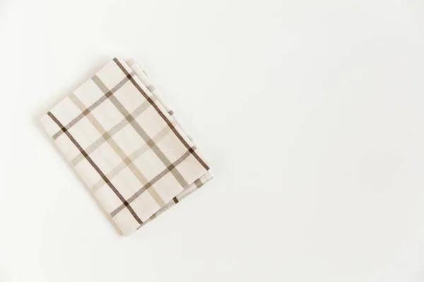 白色背景上的褐色格子布桌布 顶部视图 — 图库照片