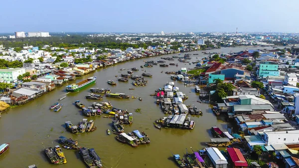 Aerial view of Cai Rang floating market, Can Tho, Vietnam. Cai Rang is famous market in mekong delta, Vietnam. Tourists, people buy and sell food, vegetable, fruits on boat, ship at river market.