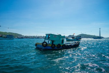Phu Quoc, Vietnam, Asya 'daki Hon Thom adası - renkli evler, mavi dalgalar ve mavi gökyüzü ile tropikal manzara, balıkçı tekneleri ve çok uzaktaki en uzun teleferik. Seyahat kavramı.