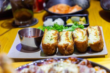 Fırında mozzarella soslu tavuk dürümü. İçinde çıtır çıtır tavuk ve mozzarella peyniri var. Tatlı ve ekşi sosla servis et. Seçici odak.