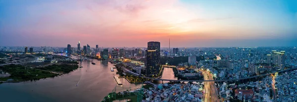 Ho Chi Minh city, Vietnam - 6 April 2021: Aerial view of Ho Chi Minh city, Vietnam. Beauty skyscrapers along river light smooth down urban development. Dramatic lighting spectacular sunset.