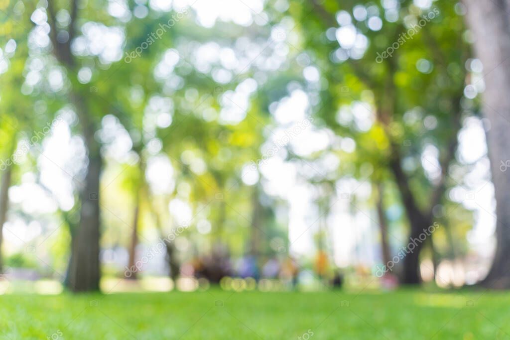 Defocused background of summer park with walking people. Blurred background of people in park, spring and summer season