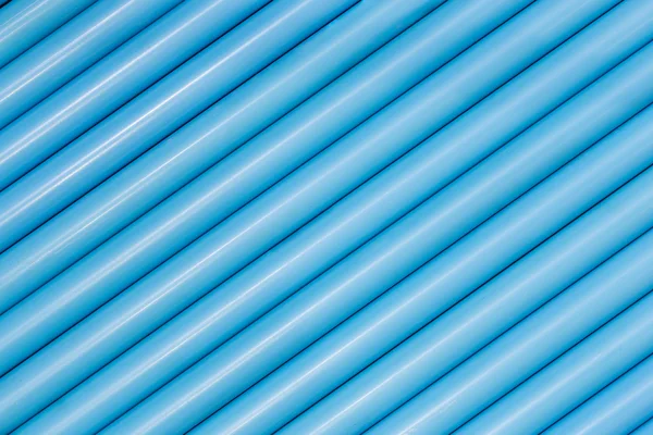 Blue pvc pipes in line for background texture — Stock Photo, Image