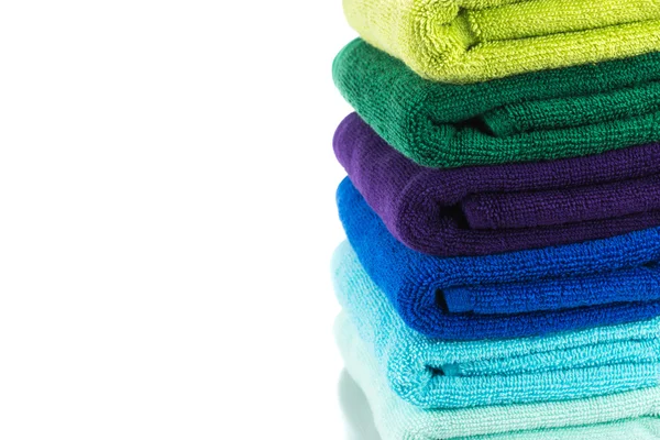 Pile of colorful clean towels isolated on white background — Stock Photo, Image