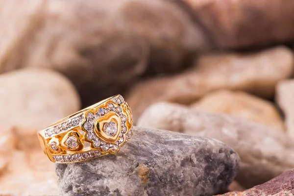 Heart shape diamond ring on blown old stones — Stock Photo, Image