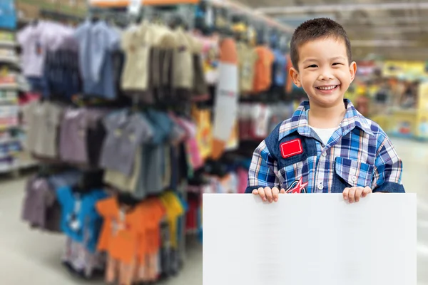 Boy standing and holding empty white board — Stock Photo, Image