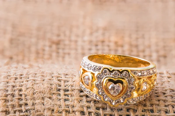 Heart shape diamond ring on burlap hessian sacking texture — Stock Photo, Image