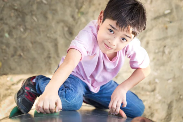Little boy climbing up brave at playground — Stock Photo, Image