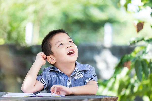 Little asian boy thinking and looks up — Stock Photo, Image