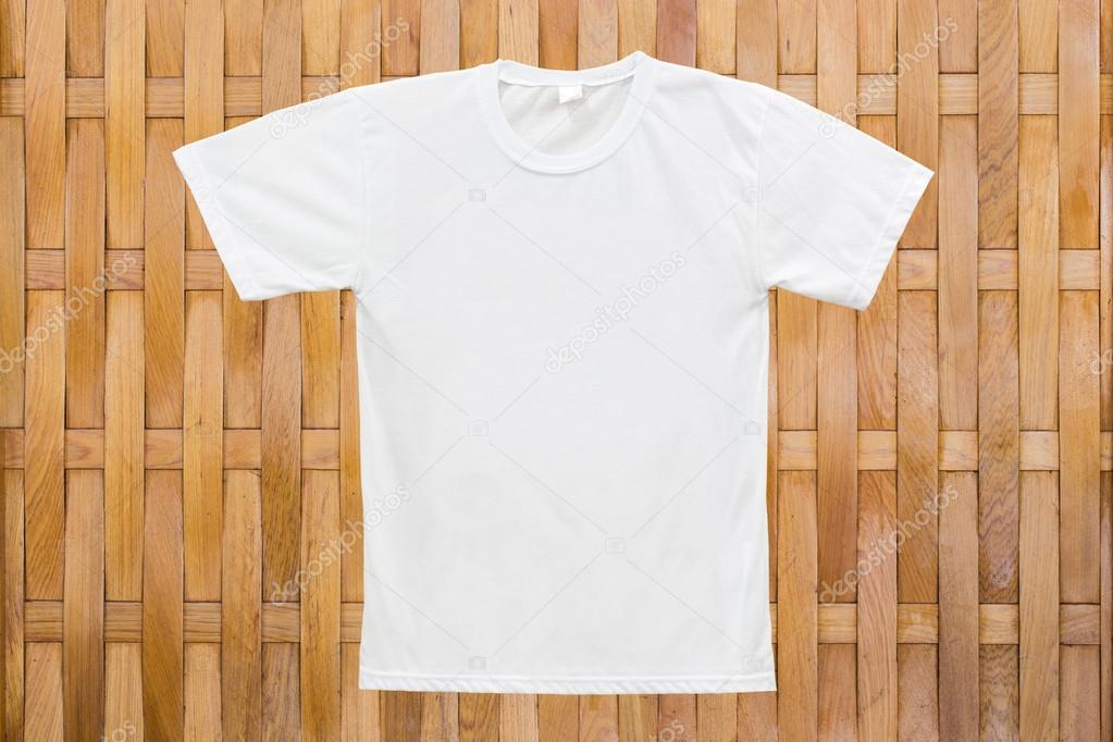 White blank T-shirt on wood texture background