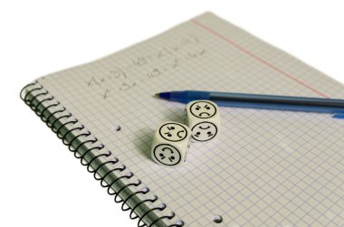 exercise book with mathemacical equation and dices with sad face clipart