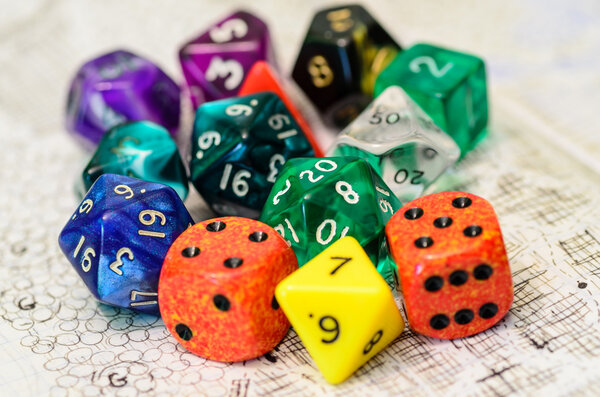 Role playing dices lying on sketch map