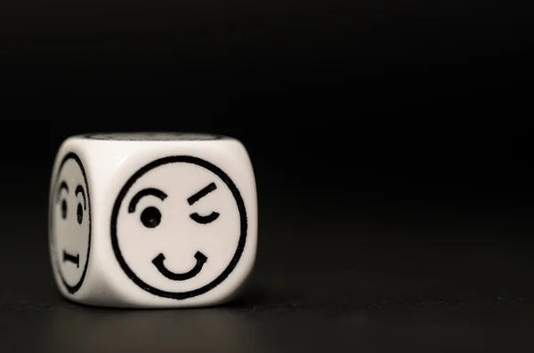 Single emoticon dice with blinking expression sketch — Stock Photo, Image