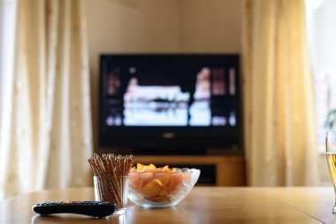televizyon, masanın üzerinde yatan atıştırmalıklar ile (film) izlerken Tv
