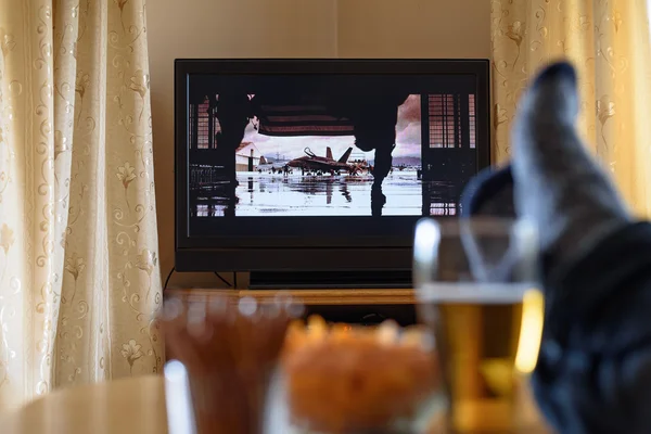 Television, TV watching (movie) with feet on table and huge amou