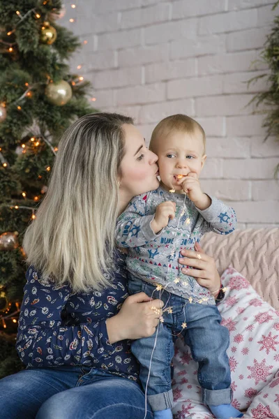 Una Hermosa Joven Sienta Sofá Con Niño Cerca Del Árbol — Foto de Stock