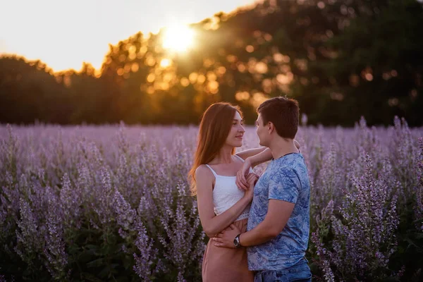 Lyckliga Par Kärleksfulla Kramar Kyssar Vid Solnedgången Nära Ett Blommande — Stockfoto