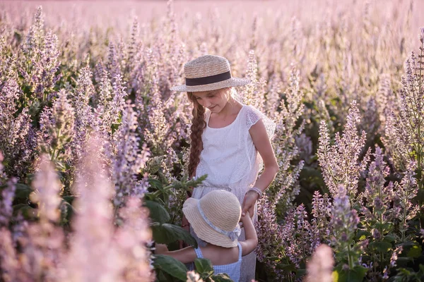 Two Little Girls White Sundresses Walking Green Field Blooming Purple — Stock Photo, Image
