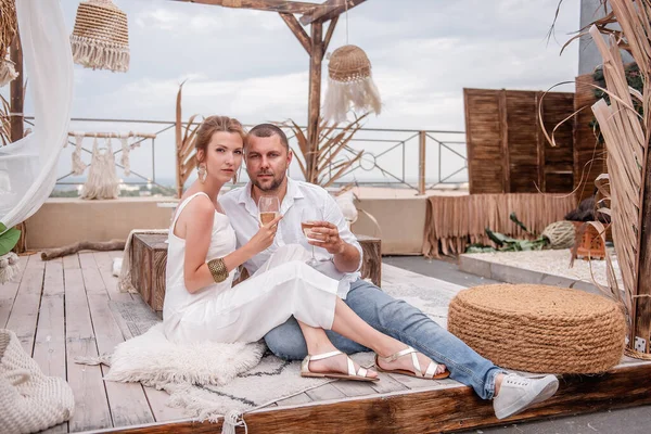 Loving Couple Sits Wooden Hut Moroccan Style Drinking White Wine — Stockfoto