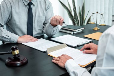 Male lawyer discussing negotiation legal case with client meeting with document contract in office, law and justice, attorney, lawsuit concept. clipart