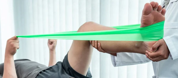 Female Physiotherapist Working Examining Treating Injured Leg Patient Doing Exercises — Stock Photo, Image