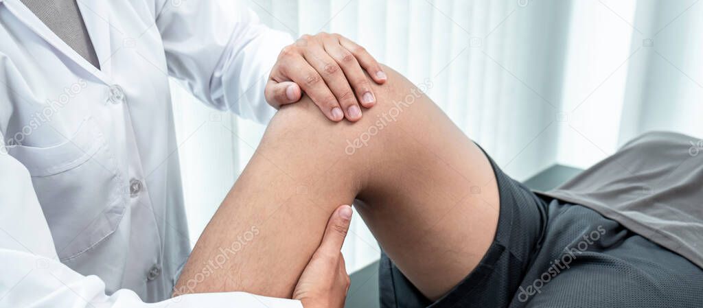 Physiotherapist working examining treating injured leg of athlete patient, Doctor doing the Rehabilitation therapy pain in clinic.