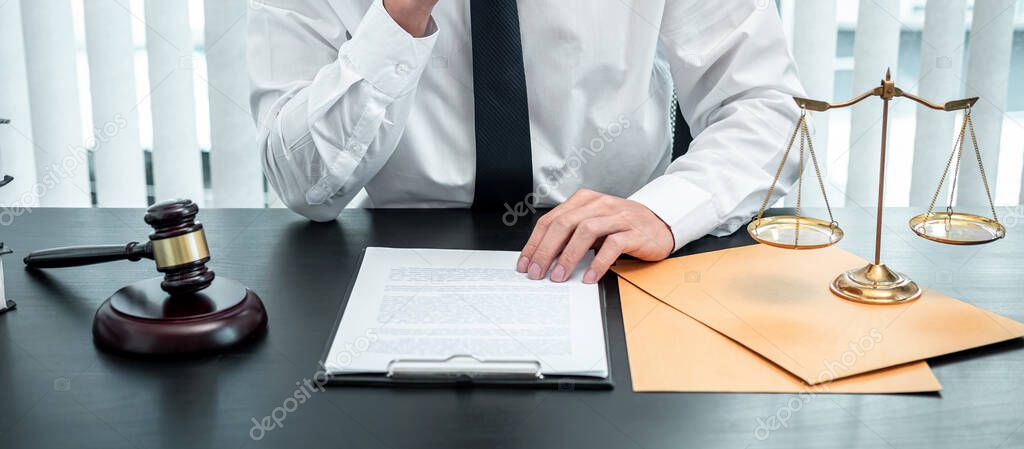 Male lawyer working with legal case document contract in office, law and justice, attorney, lawsuit concept.