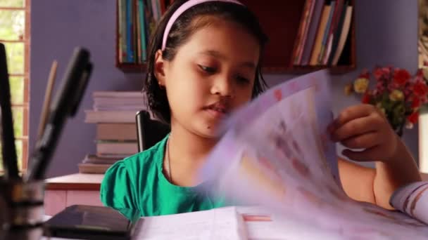 Cute Indian Girl Child Studying Reading Books Smart Phone Table — Stok video