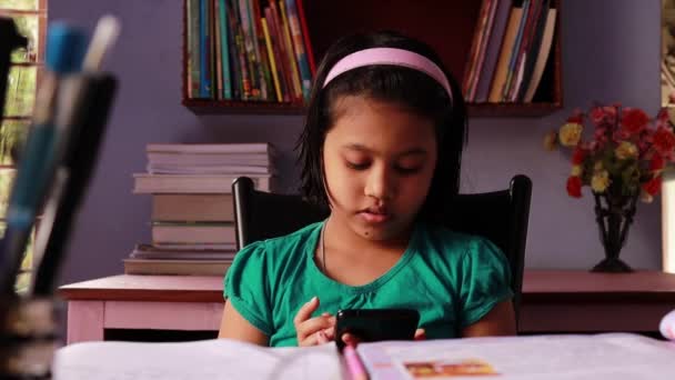 Cute Indian Girl Child Playing Surfing Smart Phone Studying — Stock videók