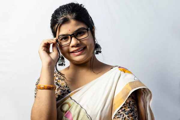 Isolated on white background an Indian office woman in saree holding her eyeglasses