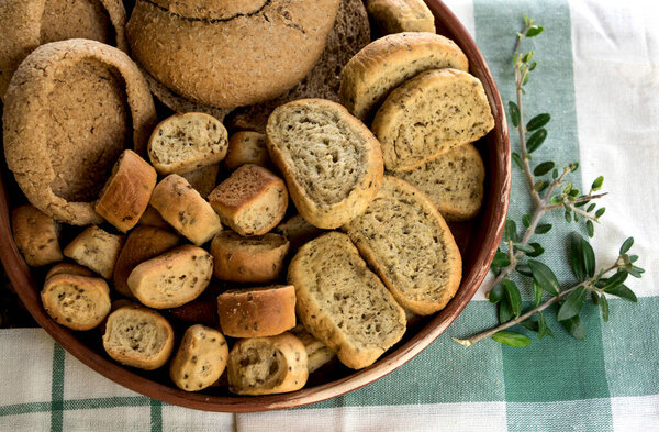 Assorted bread rusks on tablecloth. 