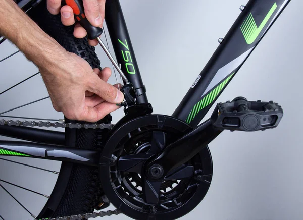 Adjusting and repairing a bike with a tool. Bicycle repair concept.