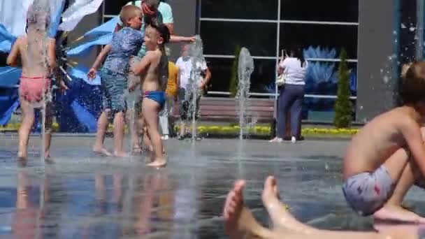 Children happy play and run in the fountain. Heat summer sunny day. Belarus Mogilev 2021 July 10 — 비디오