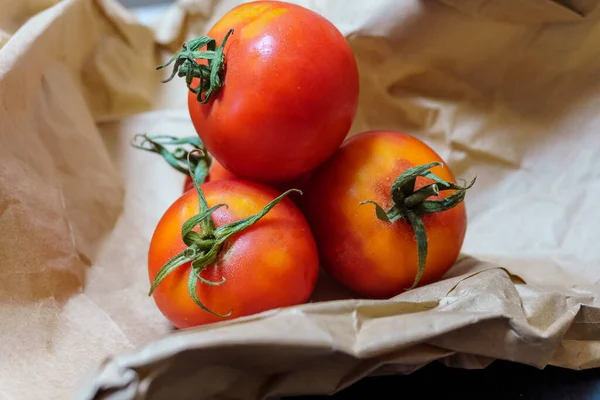 Organic ripe tomatoes on recycled paper