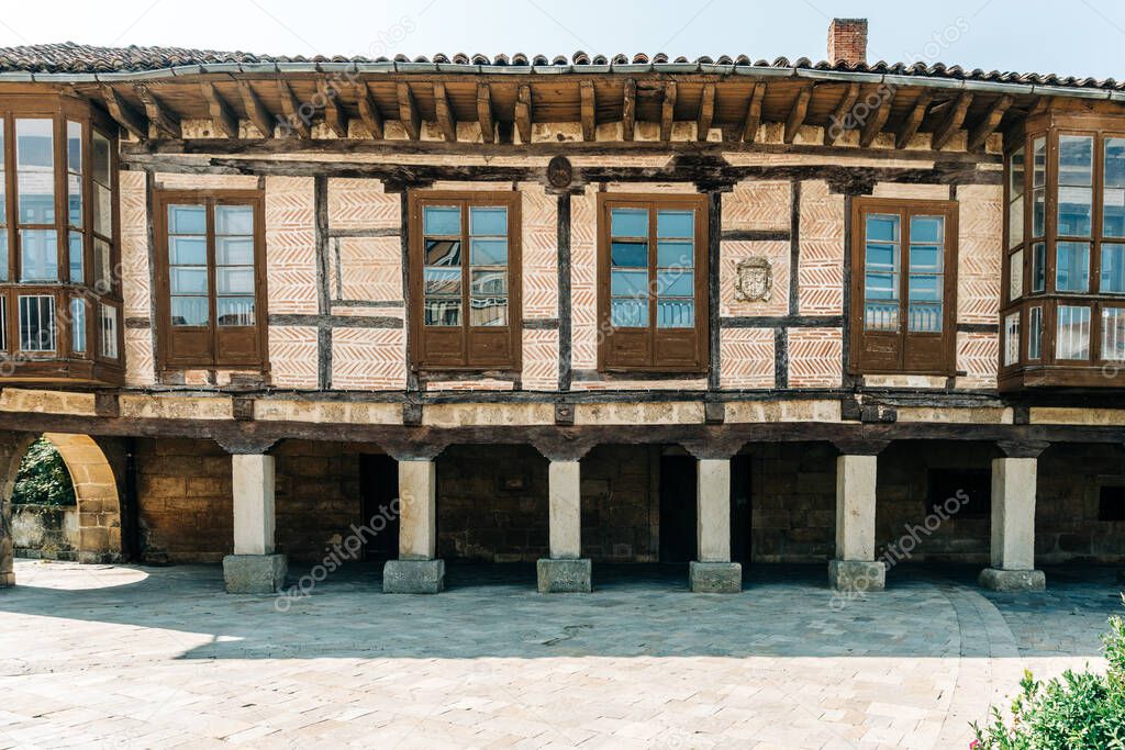 Palencia, Spain - August 21, 2021. Old building with arches in Plaza de Espana, Aguilar de Campoo, Palecia, Spain